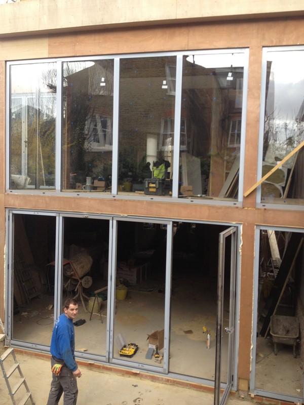 Aluminium bi-fold doors with two-storey glazing in East Ham