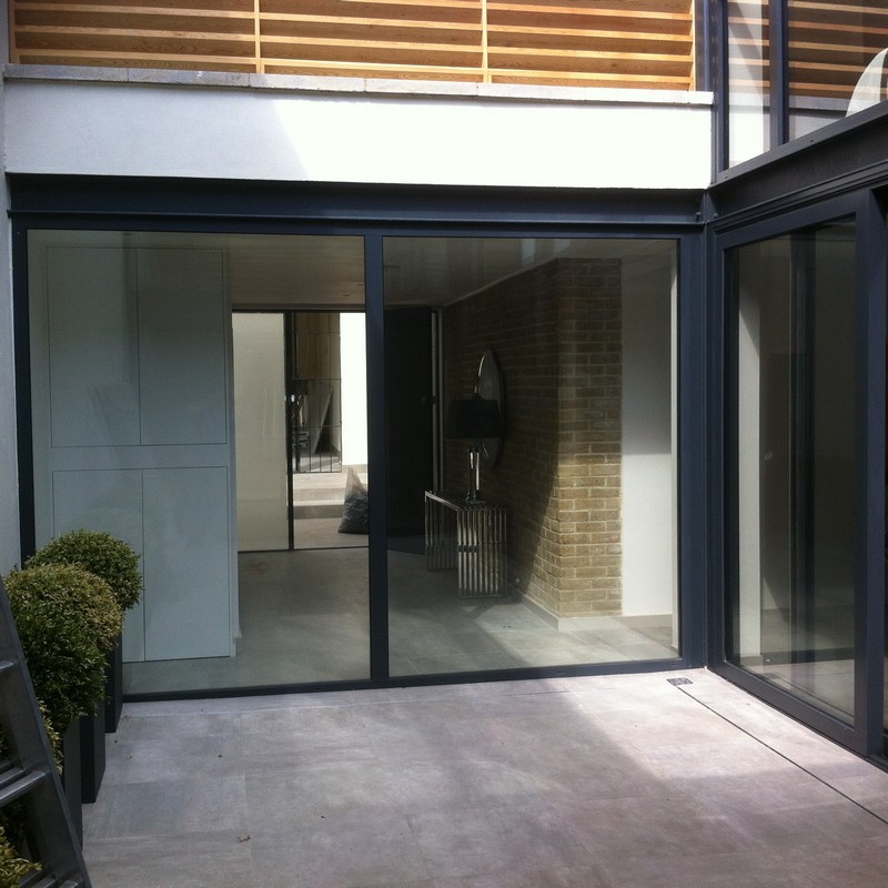 Floor-to-ceiling sliding doors opening to courtyard in East Ham