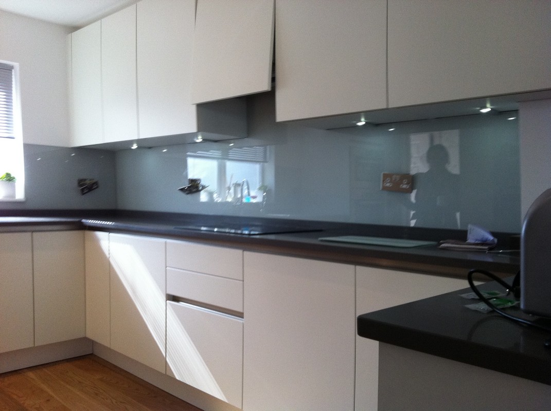 Grey glass kitchen splashback with LED lighting in East Ham