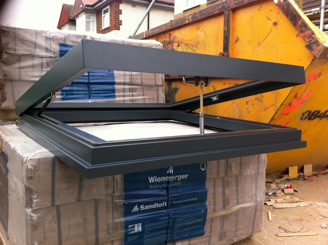 Opening flat roof skylight in anthracite grey installed in East Ham