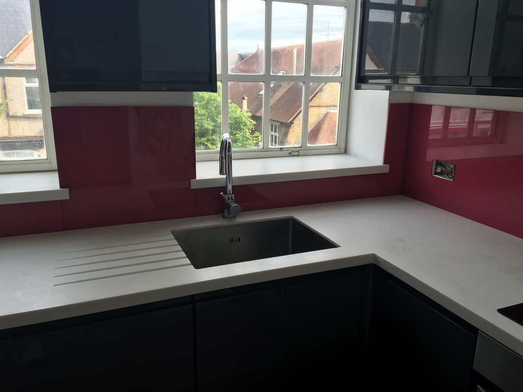 Deep plum coloured glass splashback in modern East Ham kitchen
